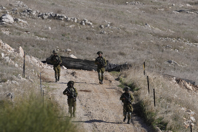 Israeli soldiers patrol near the so-called Alpha Line that separates the Israeli-annexed Golan Heights from Syria, in the town of Majdal Shams,